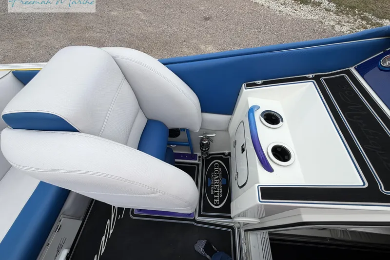 Slide: The Image of Interior of a 2000 Cigarette 30' Mystique boat with white and blue seating. - 35