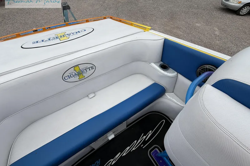 Slide: The Image of Interior of a 2000 Cigarette 30' Mystique boat with blue and white seating. - 37