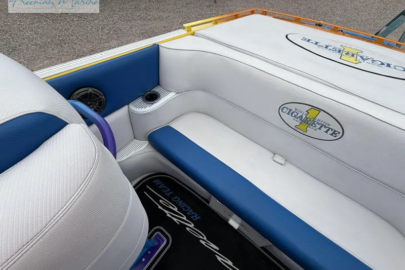 Slide: The Image of Interior of a 2000 Cigarette 30' Mystique boat with blue and white seating. - 38