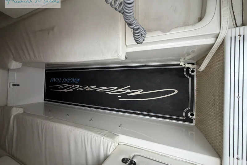 Slide: The Image of Interior of a 2000 Cigarette 30' Mystique boat with branded paneling. - 42