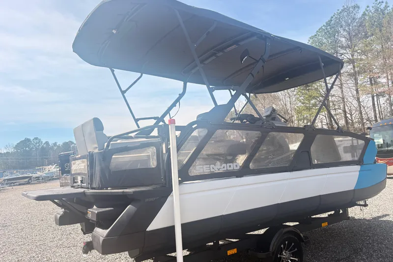 Slide: The Image of 2022 Sea Doo Switch pontoon boat with canopy, parked outdoors. - 3