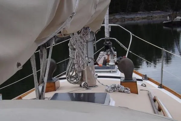 Slide: The Image of 1987 Cape Dory 36 sailboat deck with rigging and calm water backdrop. - 10