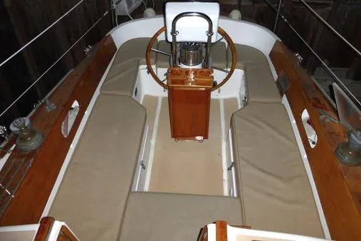 Slide: The Image of 1987 Cape Dory 36 sailboat cockpit with wooden wheel and cushioned seating. - 20