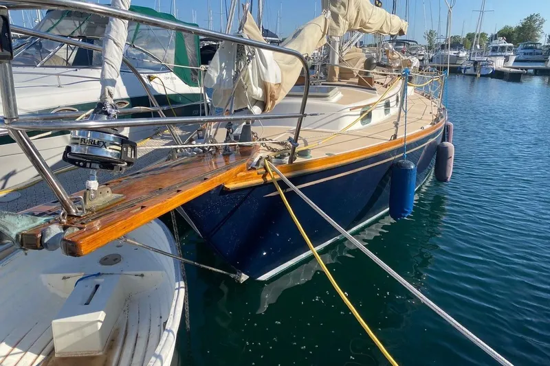 Slide: The Image of 1987 Cape Dory 36 sailboat docked in a marina, featuring a classic design. - 3