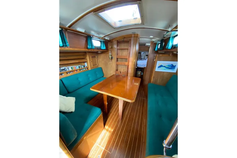 Slide: The Image of Interior of 1987 Cape Dory 36 sailboat with wooden furnishings and teal seating. - 31
