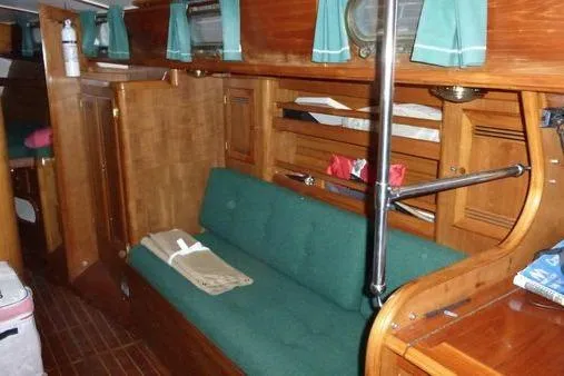 Slide: The Image of 1987 Cape Dory 36 yacht interior with wooden finish and green upholstery. - 34