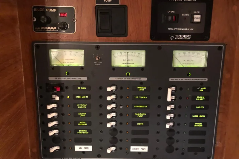Slide: The Image of Electrical control panel on a 1987 Cape Dory 36 sailboat, featuring various switches and gauges. - 41