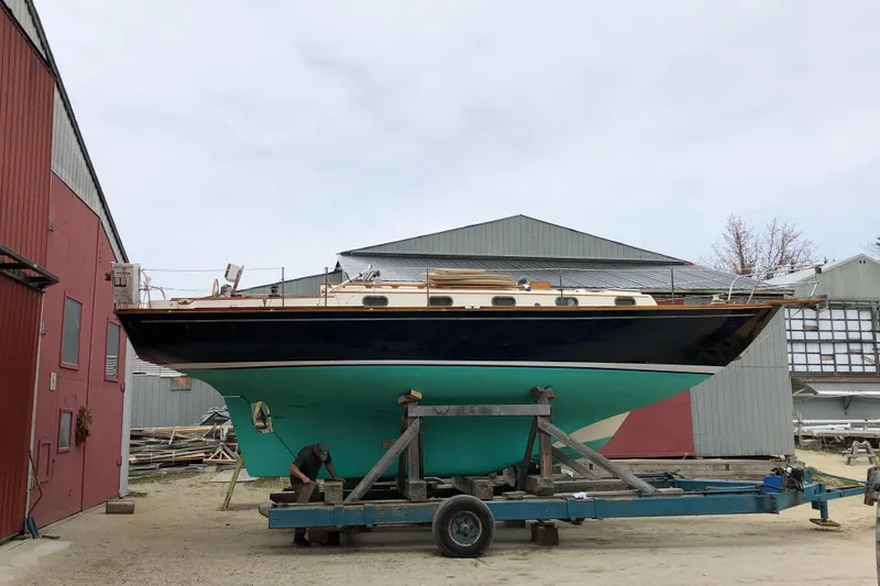 Slide: The Image of 1987 Cape Dory 36 sailboat on trailer in boatyard setting. - 48