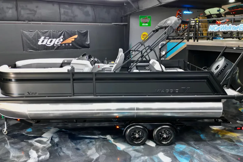 The Image of 2026 Viaggio Lago X-S 22 pontoon boat displayed indoors on a trailer. - 0