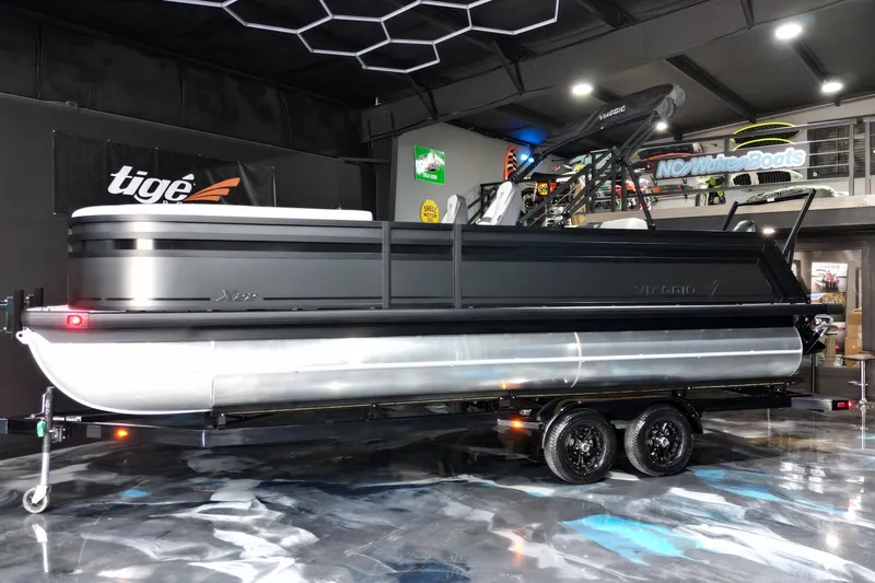 Slide: The Image of 2026 Viaggio Lago X-S 22 pontoon boat displayed indoors on a trailer. - 16
