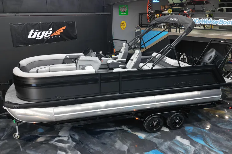 Slide: The Image of 2026 Viaggio Lago X-S 22 pontoon boat displayed indoors on a trailer. - 18