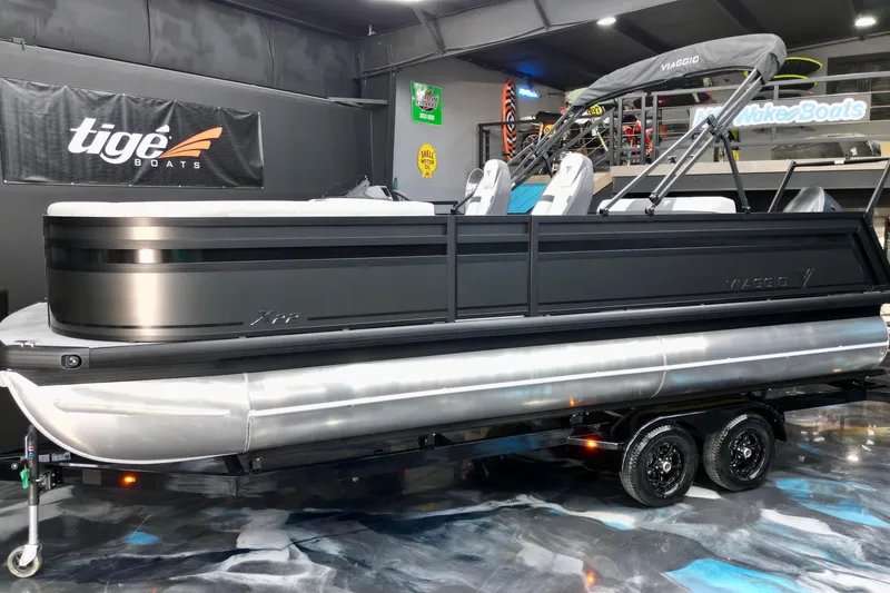 Slide: The Image of 2026 Viaggio Lago X-S 22 pontoon boat displayed indoors on a trailer. - 19