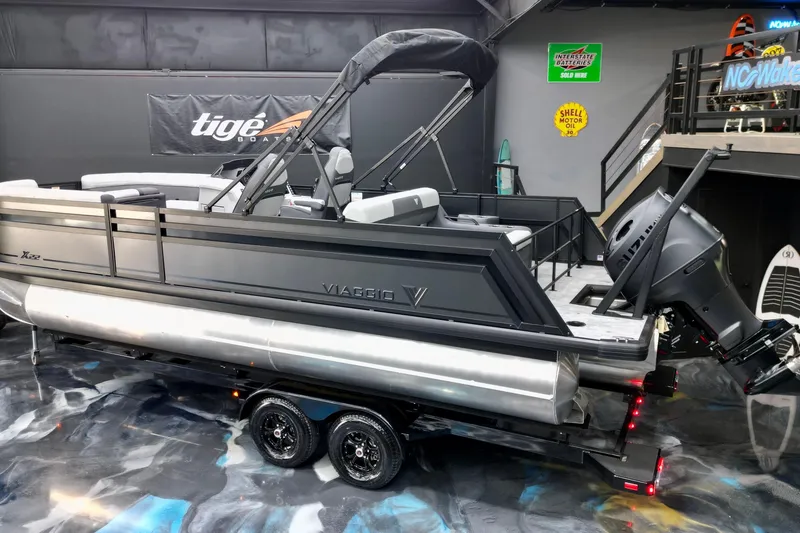 Slide: The Image of 2026 Viaggio Lago X-S 22 pontoon boat on trailer in showroom setting. - 29