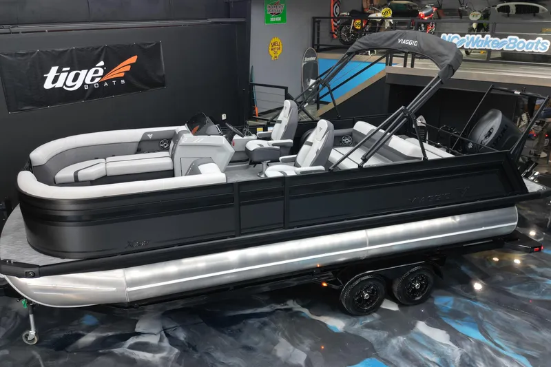 Slide: The Image of 2026 Viaggio Lago X-S 22 pontoon boat displayed indoors, featuring sleek design and modern seating. - 31