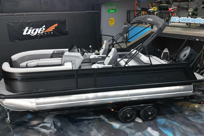 Slide: The Image of 2026 Viaggio Lago X-S 22 pontoon boat displayed indoors on a trailer. - 32