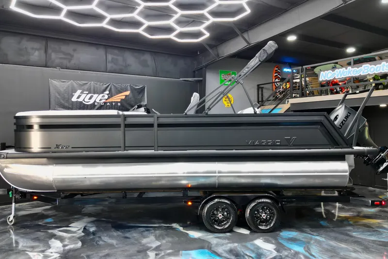 Slide: The Image of 2026 Viaggio Lago X-S 22 pontoon boat in showroom with modern lighting. - 7