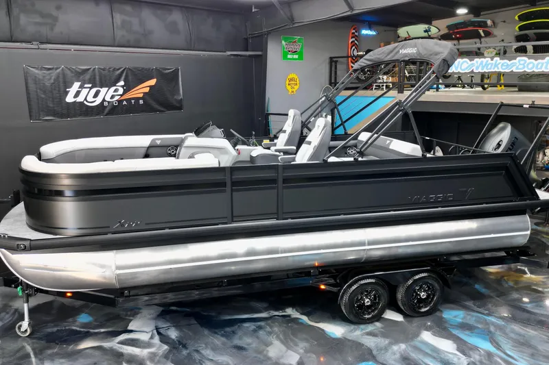 Slide: The Image of 2026 Viaggio Lago X-S 22 pontoon boat displayed indoors on a trailer. - 9