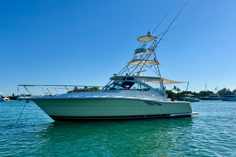 Slide: The Image of 2004 Tiara Yachts 3800 Open on clear blue water under a sunny sky. - 0