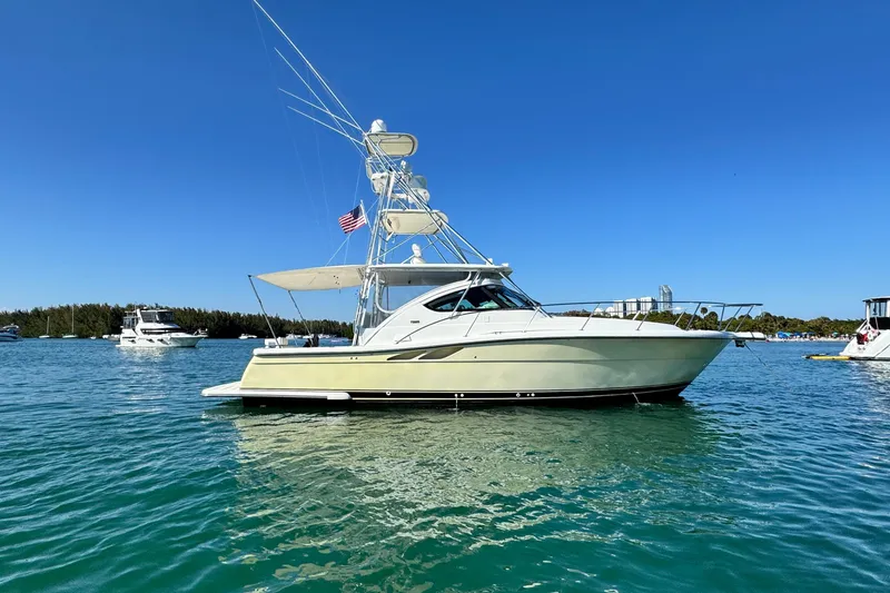 Slide: The Image of 2004 Tiara Yachts 3800 Open in calm waters, clear sky, side view. - 1