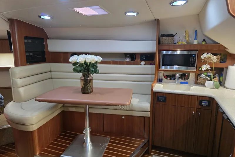 Slide: The Image of Luxurious interior of a 2004 Tiara Yachts 3800 Open with dining area and kitchenette. - 11
