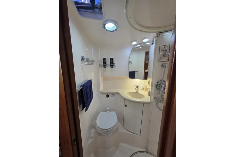 Slide: The Image of Bathroom interior of 2004 Tiara Yachts 3800 Open, featuring sink and toilet. - 12
