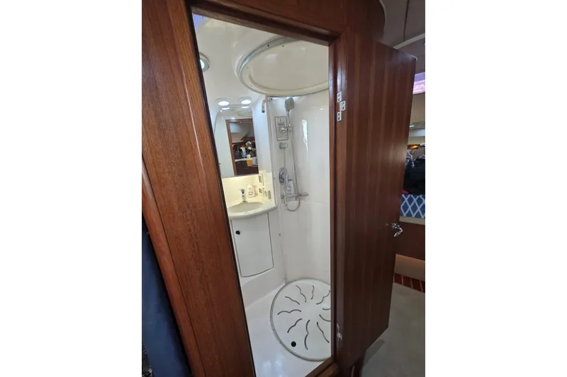 Slide: The Image of Bathroom interior of 2004 Tiara Yachts 3800 Open, featuring shower and wooden door. - 13