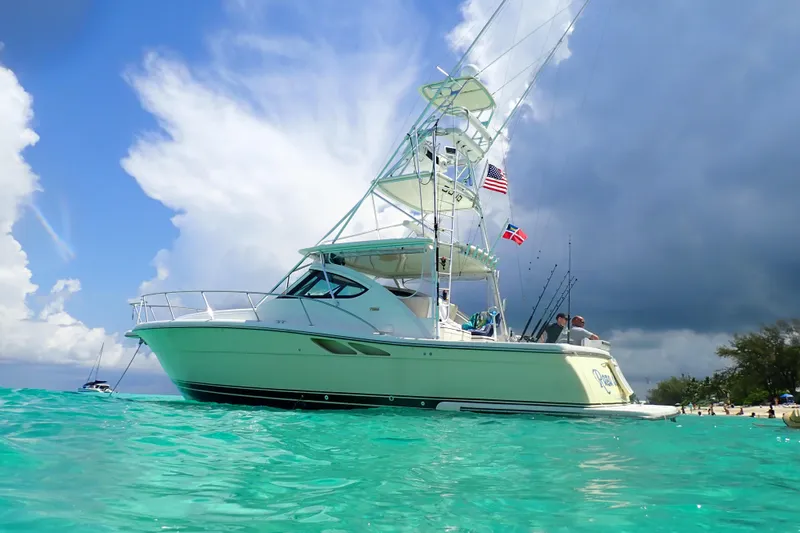 Slide: The Image of 2004 Tiara Yachts 3800 Open on turquoise water under a dramatic sky. - 2
