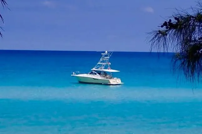 Slide: The Image of 2004 Tiara Yachts 3800 Open on tranquil turquoise sea under clear blue sky. - 3