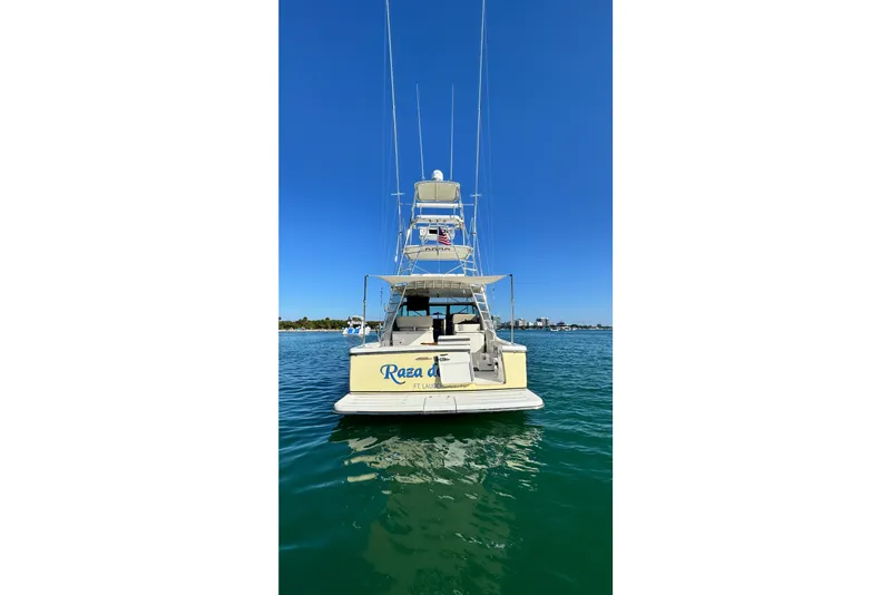 Slide: The Image of 2004 Tiara Yachts 3800 Open on water, rear view, clear blue sky. - 4