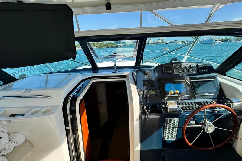 Slide: The Image of 2004 Tiara Yachts 3800 Open helm with navigation equipment and ocean view. - 6