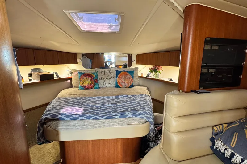 Slide: The Image of Luxurious 2004 Tiara Yachts 3800 Open cabin interior with cozy bed and elegant decor. - 9