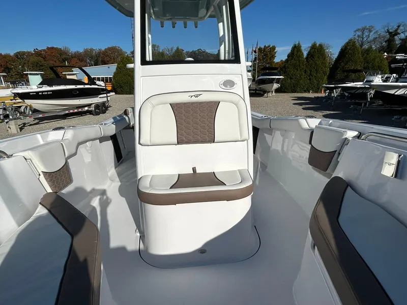 Slide: The Image of 2025 Tidewater 232 LXF boat interior with cushioned seating and sleek design. - 13