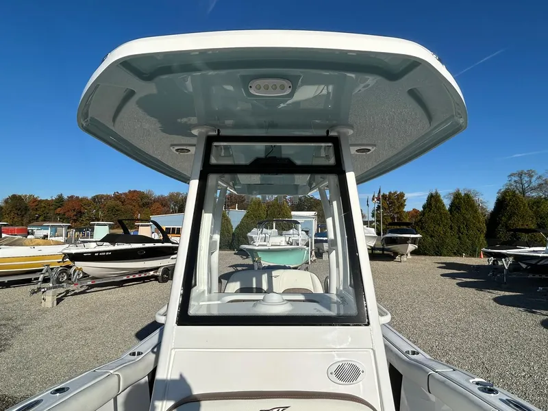 Slide: The Image of 2025 Tidewater 232 LXF boat, front view, in a sunny outdoor showroom. - 14