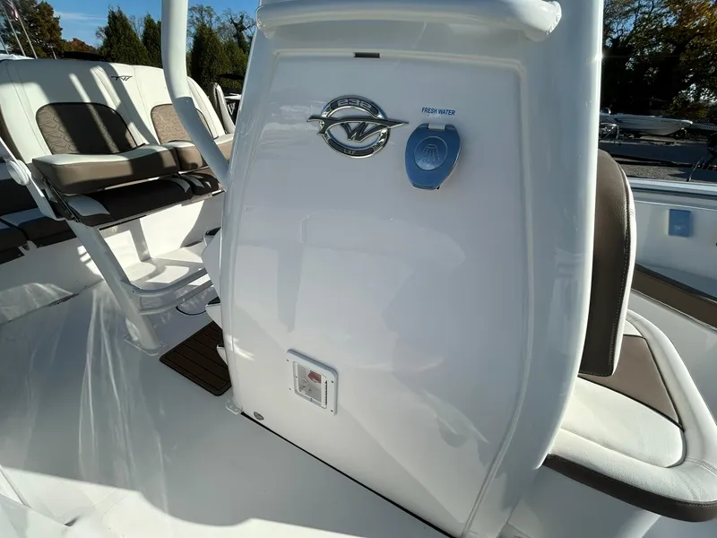Slide: The Image of 2025 Tidewater 232 LXF boat interior with seating and control panel. - 25