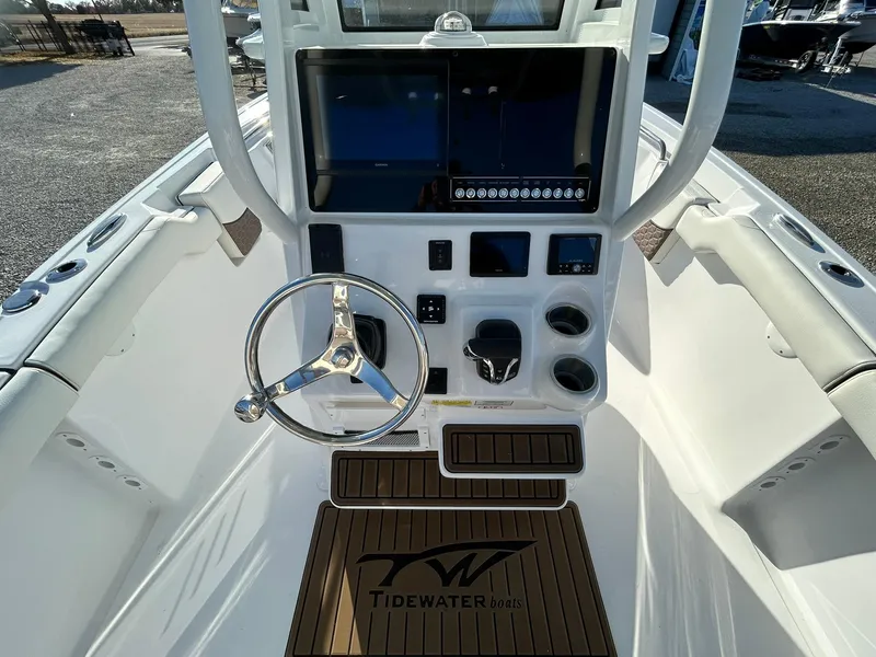 Slide: The Image of 2025 Tidewater 232 LXF boat cockpit with steering wheel and control panel. - 27