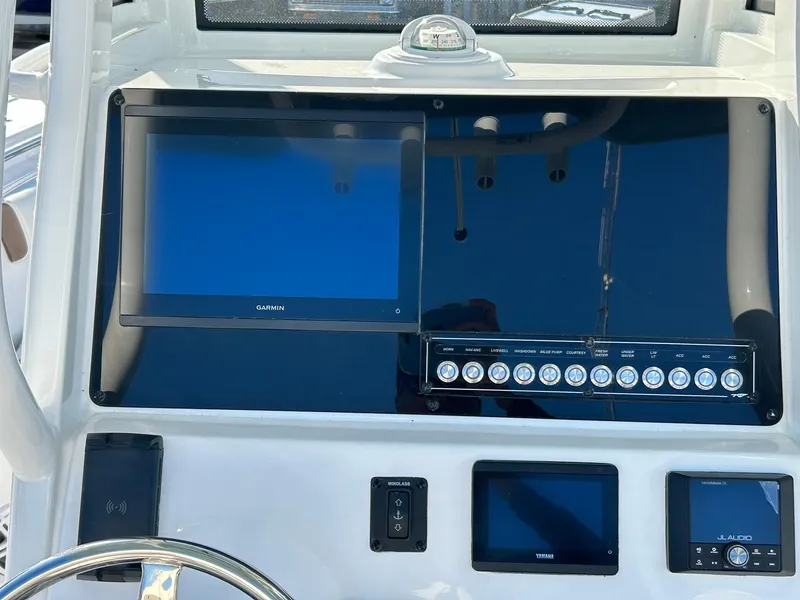 Slide: The Image of Dashboard of 2025 Tidewater 232 LXF boat with modern navigation screens. - 28