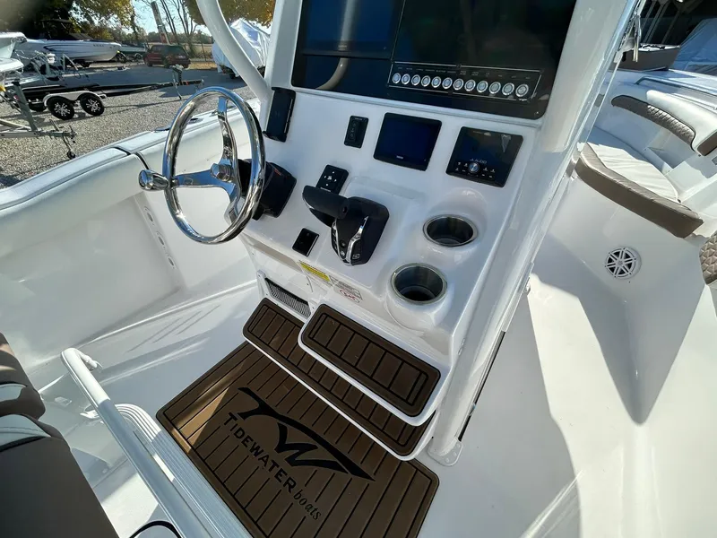 Slide: The Image of 2025 Tidewater 232 LXF boat console with steering wheel and controls. - 33