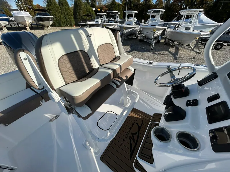 Slide: The Image of 2025 Tidewater 232 LXF boat interior with dual seats and steering console. - 37