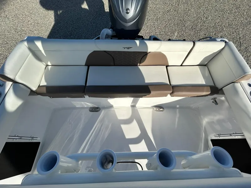 Slide: The Image of 2025 Tidewater 232 LXF boat interior with cushioned seating and rod holders. - 39