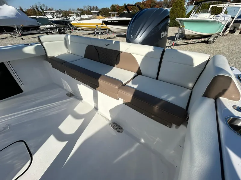 Slide: The Image of 2025 Tidewater 232 LXF boat interior with cushioned seating and Yamaha engine. - 41