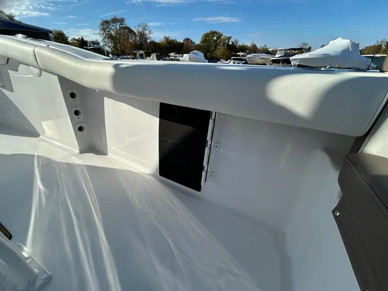 Slide: The Image of 2025 Tidewater 232 LXF boat interior with white seating and storage compartment. - 42