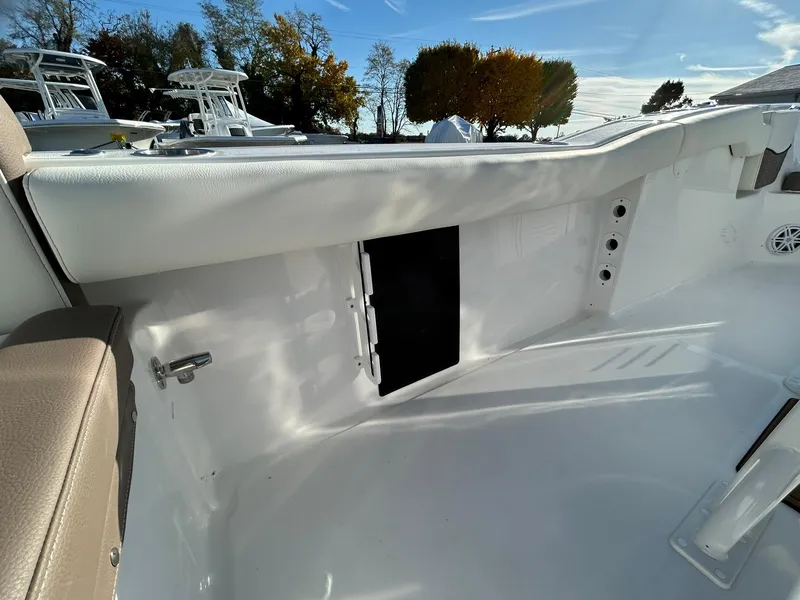 Slide: The Image of 2025 Tidewater 232 LXF boat interior with white seating and storage compartment. - 43