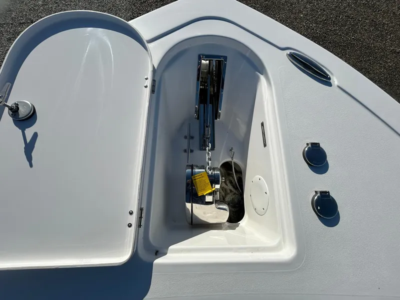 Slide: The Image of Anchor compartment of 2025 Tidewater 232 LXF boat, open with visible chain and fittings. - 6