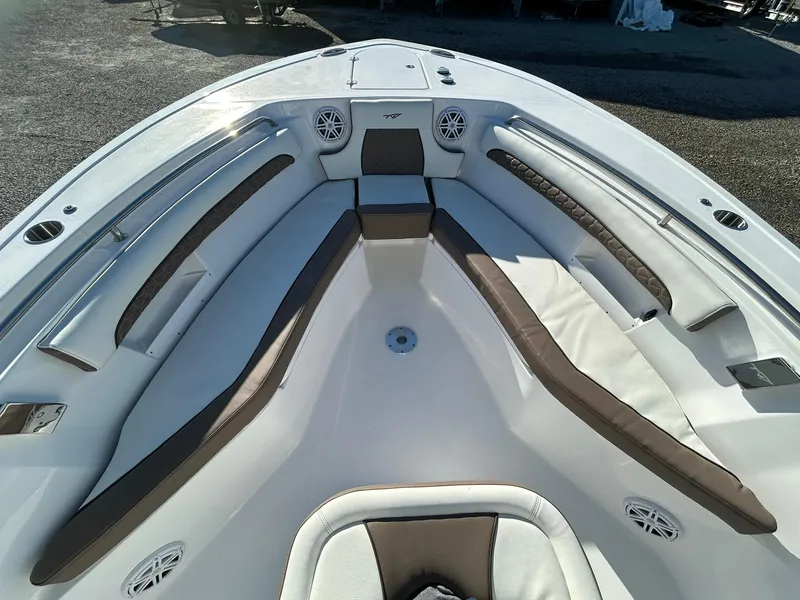 Slide: The Image of 2025 Tidewater 232 LXF boat interior with cushioned seating and speakers. - 7