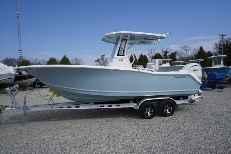 Slide: The Image of 2026 Tidewater 232 LXF boat on trailer, displayed outdoors under clear blue sky. - 73