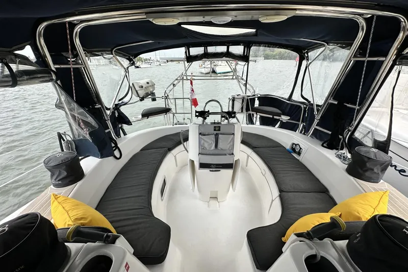 Slide: The Image of Luxurious 2002 Hunter 466 yacht cockpit with cushioned seating and modern navigation equipment. - 10