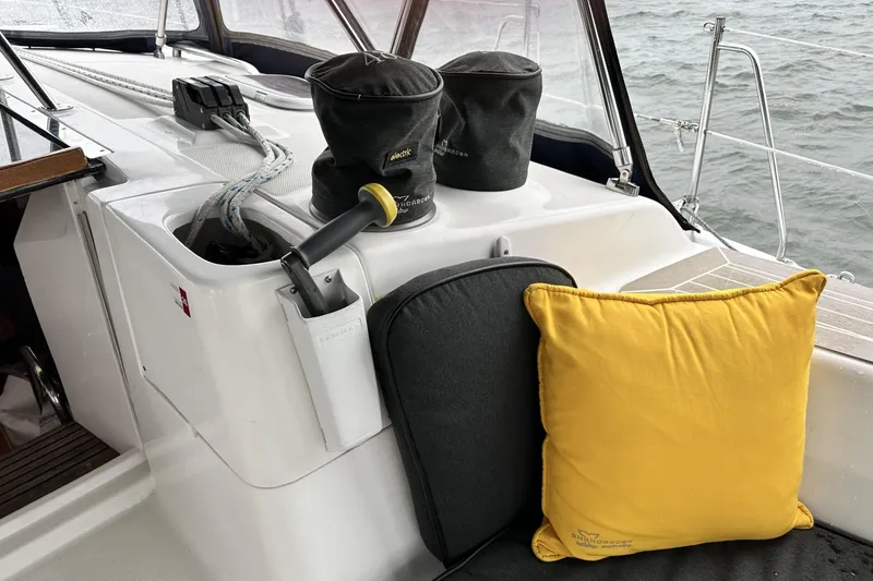 Slide: The Image of Sailboat cockpit with ropes, winches, and cushions on a Hunter 466, 2002 model. - 12