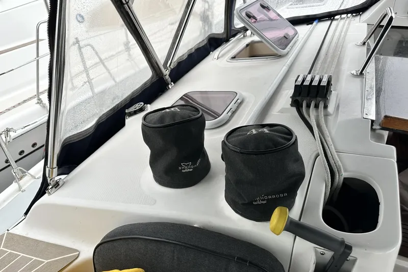 Slide: The Image of Cockpit of 2002 Hunter 466 sailboat with winch covers and control lines. - 13