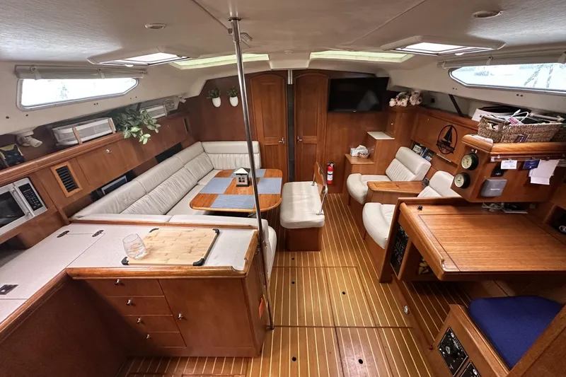 Slide: The Image of Luxurious interior of a 2002 Hunter 466 yacht with wooden furnishings and cozy seating. - 15