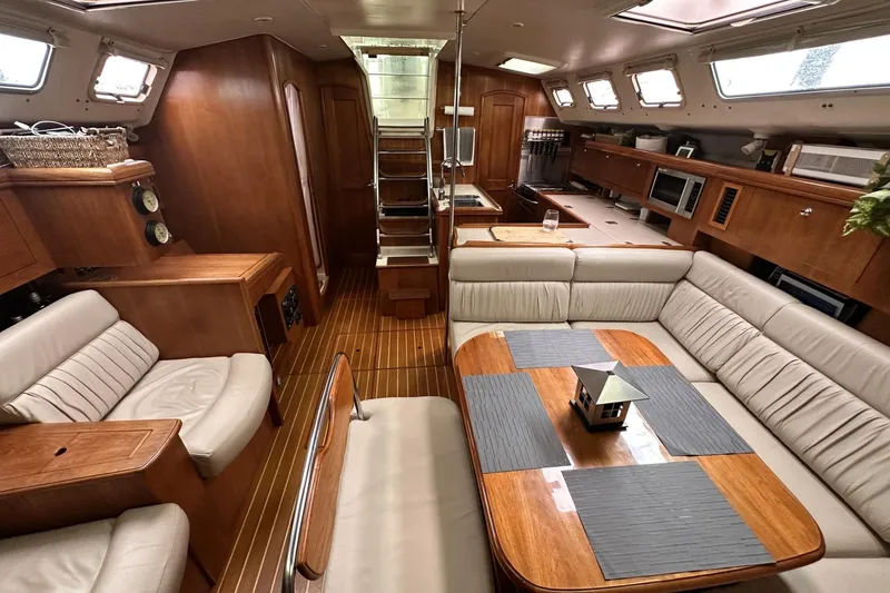 Slide: The Image of Luxurious 2002 Hunter 466 yacht interior with elegant wood finishes and comfortable seating. - 16